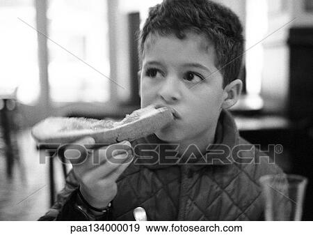 Young child eating bread, portrait, b&w. View Large Photo Image Stock Photo - Young child eating bread, portrait, b&w.. Fotosearch