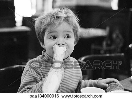 Young child eating bread, portrait, b&w. View Large Photo Image Stock Photograph - Young child eating bread, portrait, b&w.. Fotosearch