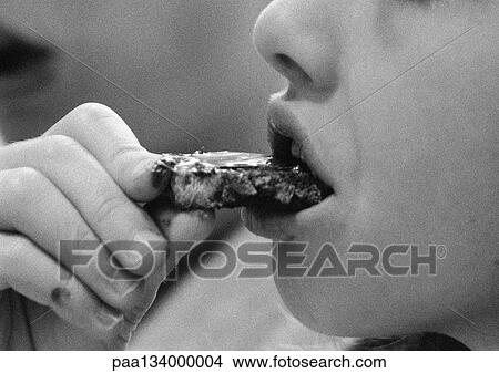 Young child eating, close-up, b&w. View Large Photo Image Picture - Young child eating, close-up, b&w.. Fotosearch