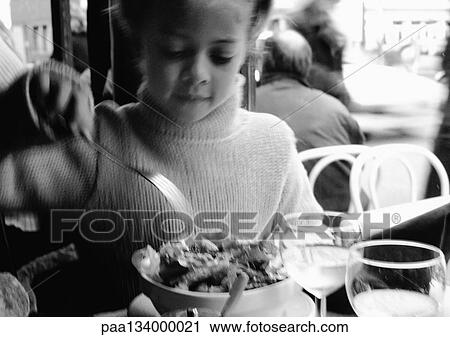 Young girl eating in restaurant, portrait, b&w. View Large Photo Image Stock Image - Young girl eating in restaurant, portrait, b&w.. Fotosearch