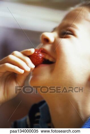 Young girl eating strawberry, laughing, side view, close-up. View Large Photo Image Stock Photography - Young girl eating strawberry, laughing, side view, close-up.. Fotosearch