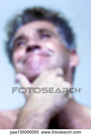 Mature man holding chin and smiling, close-up, portrait View Large Photo Image Stock Image - Mature man holding chin and smiling, close-up, portrait. Fotosearch
