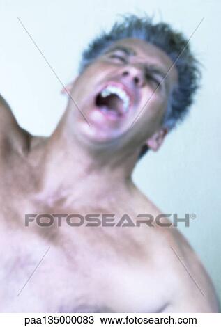 Stock Image - Mature man screaming, close-up, portrait. Fotosearch