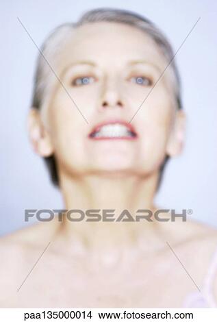 Picture - Mature woman gritting teeth, close-up, portrait. Fotosearch