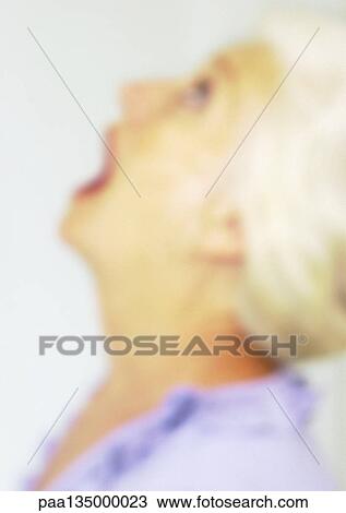 Mature woman looking up with mouth open, close-up, portrait, side view, blurred View Large Photo Image Stock Image - Mature woman looking up with mouth open, close-up, portrait, side view, blurred. Fotosearch