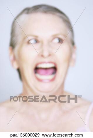 Mature woman with mouth wide open, close-up, portrait, blurred View Large Photo Image Stock Photo - Mature woman with mouth wide open, close-up, portrait, blurred. Fotosearch