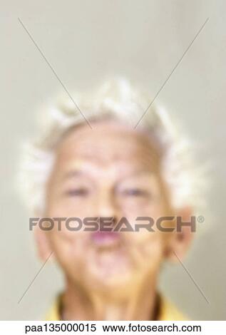 Stock Photography - Senior man puckering lips, close-up, portrait. Fotosearch
