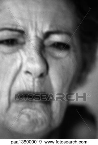 Stock Photo - Senior woman frowning, close-up, portrait, b&w. Fotosearch