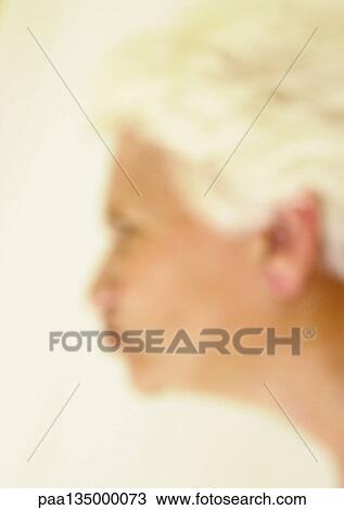 Senior woman making face, side view, blurred View Large Photo Image Stock Image - Senior woman making face, side view, blurred. Fotosearch