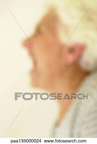 Senior woman screaming, side view, close-up, portrait, blurred View Large Photo Image Picture - Senior woman screaming, side view, close-up, portrait, blurred. Fotosearch