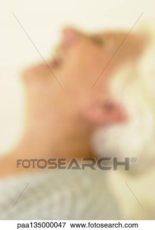 Senior woman with head back, side view, blurred View Large Photo Image Stock Photo - Senior woman with head back, side view, blurred. Fotosearch