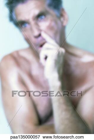 Stock Photo - Topless mature man making face, close-up, portrait, blurred. Fotosearch