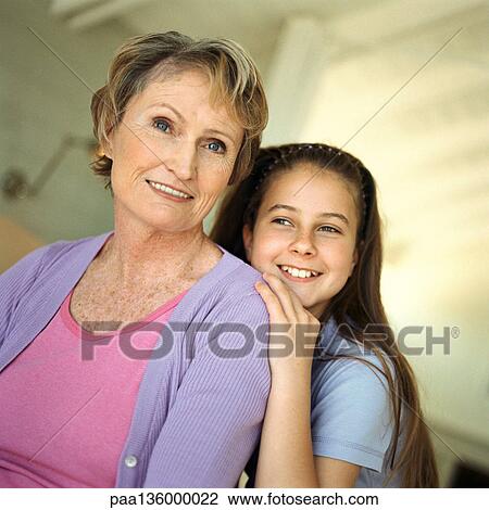 Girl behind mature woman resting head on woman's shoulder View Large Photo Image Stock Image - Girl behind mature woman resting head on woman's shoulder. Fotosearch