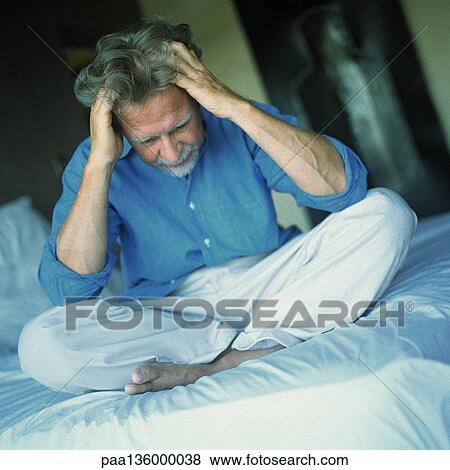 Man sitting indian style on bed, both hands in hair View Large Photo Image Stock Photo - Man sitting indian style on bed, both hands in hair. Fotosearch