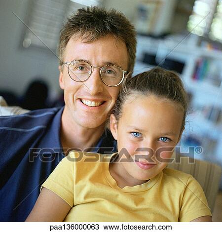 Stock Image - Man wearing glasses and girl, portrait. Fotosearch