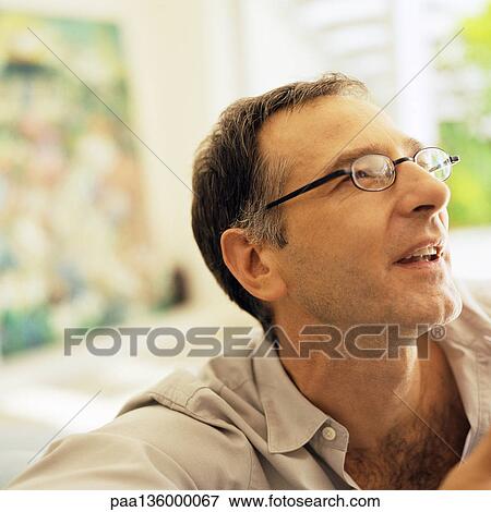 Man wearing glasses and looking up, portrait View Large Photo Image Stock Photo - Man wearing glasses and looking up, portrait. Fotosearch