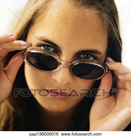 Stock Photograph - Portrait of girl wearing sunglasses. Fotosearch