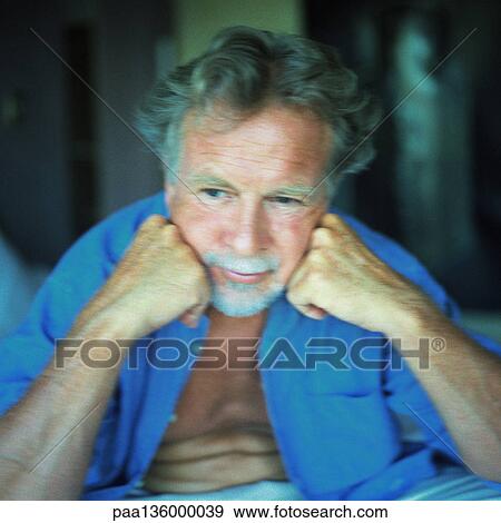 Stock Photo - Portrait of man with head resting on hands. Fotosearch