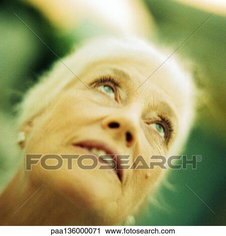 Portrait of senior woman looking up View Large Photo Image Stock Image - Portrait of senior woman looking up. Fotosearch