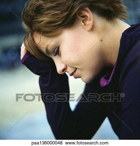 Stock Photo - Profile of young woman with head on hand. Fotosearch