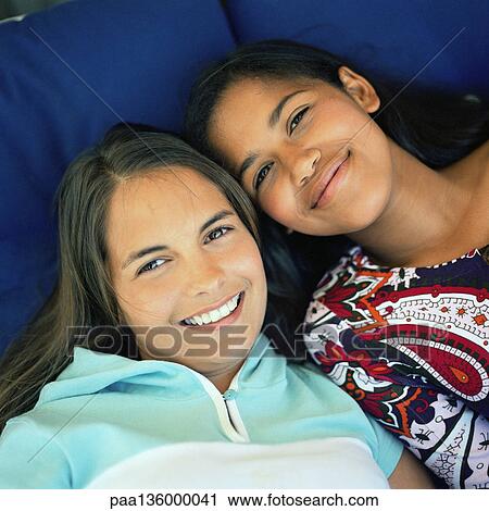 Stock Image - Two girls, looking at camera. Fotosearch