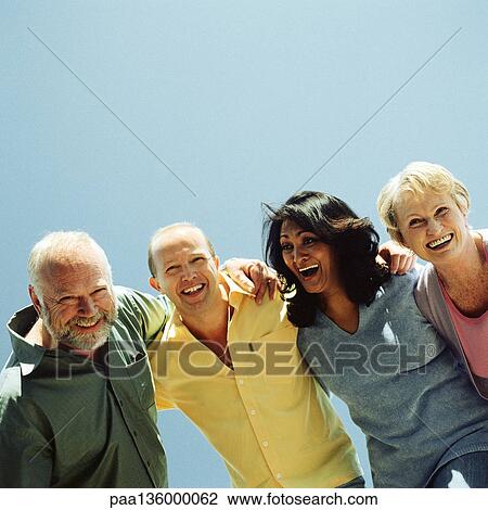 Two men and two women arms around each others' shoulder laughing and smiling View Large Photo Image Stock Image - Two men and two women arms around each others' shoulder laughing and smiling. Fotosearch