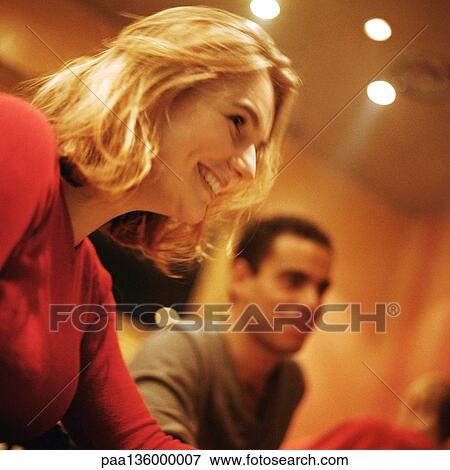 Stock Photo - Young woman and man, side view. Fotosearch