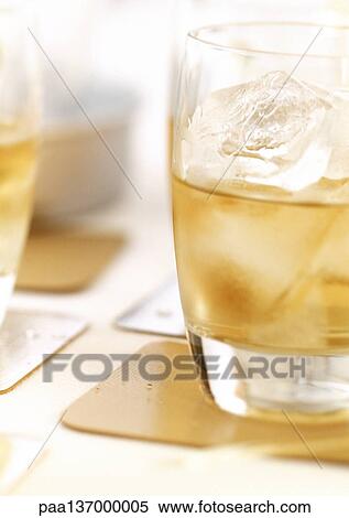 Alcoholic drink with ice cubes. View Large Photo Image Stock Photography - Alcoholic drink with ice cubes.. Fotosearch