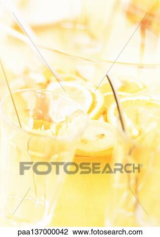 Stock Image - Bowl of punch and glasses, blurred, close-up.. Fotosearch