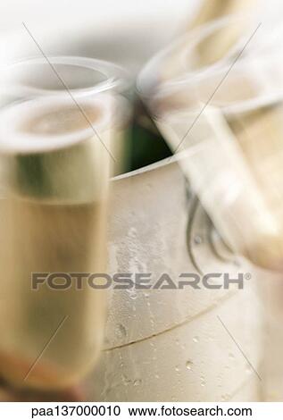 Stock Image - Champagne glasses being clinked. Fotosearch