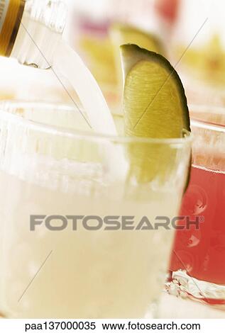 Stock Photography - Cocktail with slice of lime.. Fotosearch