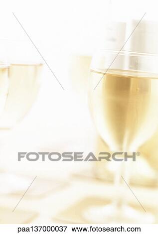 Glasses of white wine, blurred. View Large Photo Image Stock Photo - Glasses of white wine, blurred.. Fotosearch