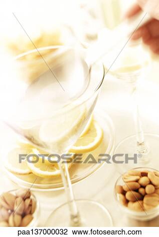 Two martini glasses, nuts and slices of lemon. View Large Photo Image Stock Image - Two martini glasses, nuts and slices of lemon.. Fotosearch