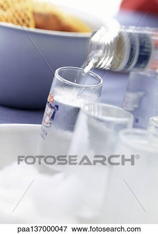 Stock Photo - Vodka being poured, close-up.. Fotosearch