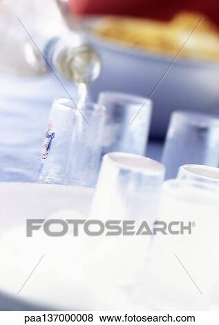 Vodka being poured into glasses View Large Photo Image Stock Photo - Vodka being poured into glasses. Fotosearch