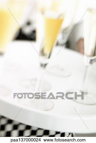 Picture - Waiter carrying tray of Champagne, blurred motion, close-up.. Fotosearch