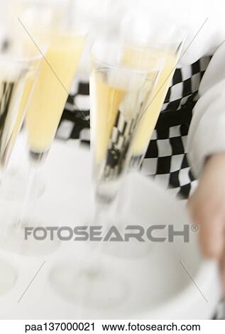 Waiter carrying tray of Champagne, blurred motion, close-up. View Large Photo Image Stock Image - Waiter carrying tray of Champagne, blurred motion, close-up.. Fotosearch