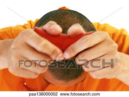 Stock Image - Buddhist monk holding hands over head, holding scroll, close-up. Fotosearch