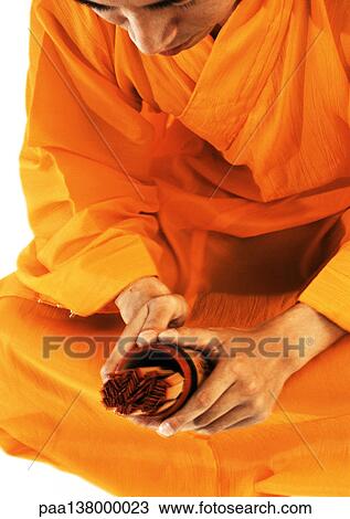Buddhist monk meditating, holding devotional objects View Large Photo Image Stock Image - Buddhist monk meditating, holding devotional objects. Fotosearch