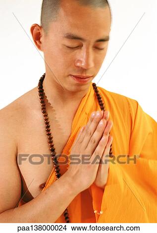 Buddhist monk meditating with hands together View Large Photo Image Picture - Buddhist monk meditating with hands together. Fotosearch