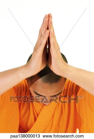Buddhist monk meditating with hands together over head View Large Photo Image Stock Image - Buddhist monk meditating with hands together over head. Fotosearch