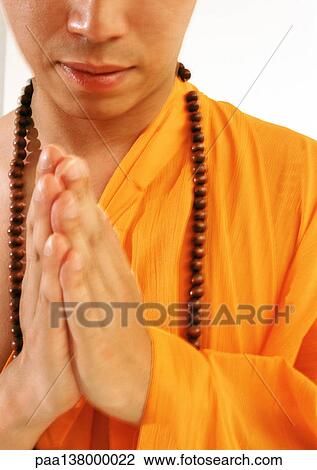 Buddhist monk meditating with hands together, close-up View Large Photo Image Stock Image - Buddhist monk meditating with hands together, close-up. Fotosearch