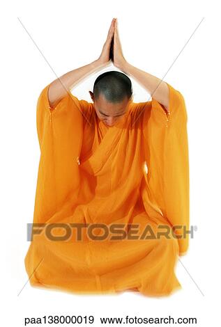 Buddhist monk meditating with hands together over head View Large Photo Image Stock Photo - Buddhist monk meditating with hands together over head. Fotosearch