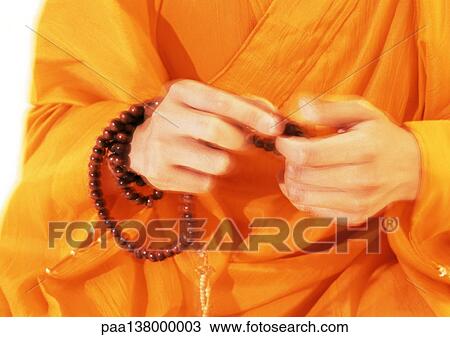 Buddhist monk's hands holding prayer beads View Large Photo Image Stock Image - Buddhist monk's hands holding prayer beads. Fotosearch