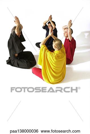 Group of people sitting on floor indian style, meditating with hands togther over heads View Large Photo Image Stock Photograph - Group of people sitting on floor indian style, meditating with hands togther over heads. Fotosearch