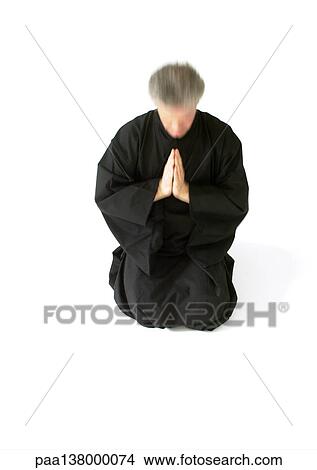 Man kneeling on floor, hands together View Large Photo Image Picture - Man kneeling on floor, hands together. Fotosearch