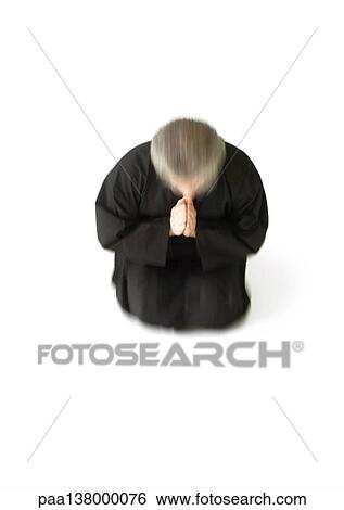 Man kneeling on floor, hands together, blurred motion View Large Photo Image Stock Photograph - Man kneeling on floor, hands together, blurred motion. Fotosearch