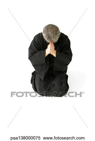 Man kneeling on floor, hands together View Large Photo Image Stock Photography - Man kneeling on floor, hands together. Fotosearch
