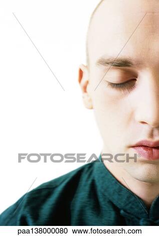 Stock Image - Man meditating, close-up. Fotosearch