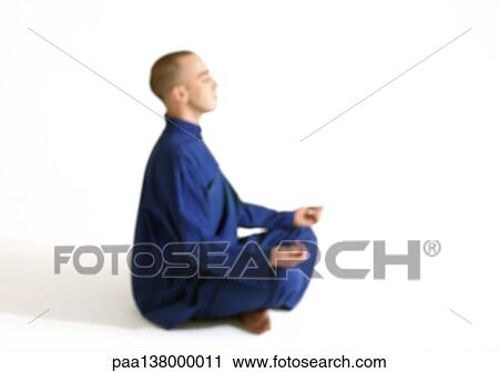 Man sitting in lotus position, meditating, side view View Large Photo Image Stock Image - Man sitting in lotus position, meditating, side view. Fotosearch
